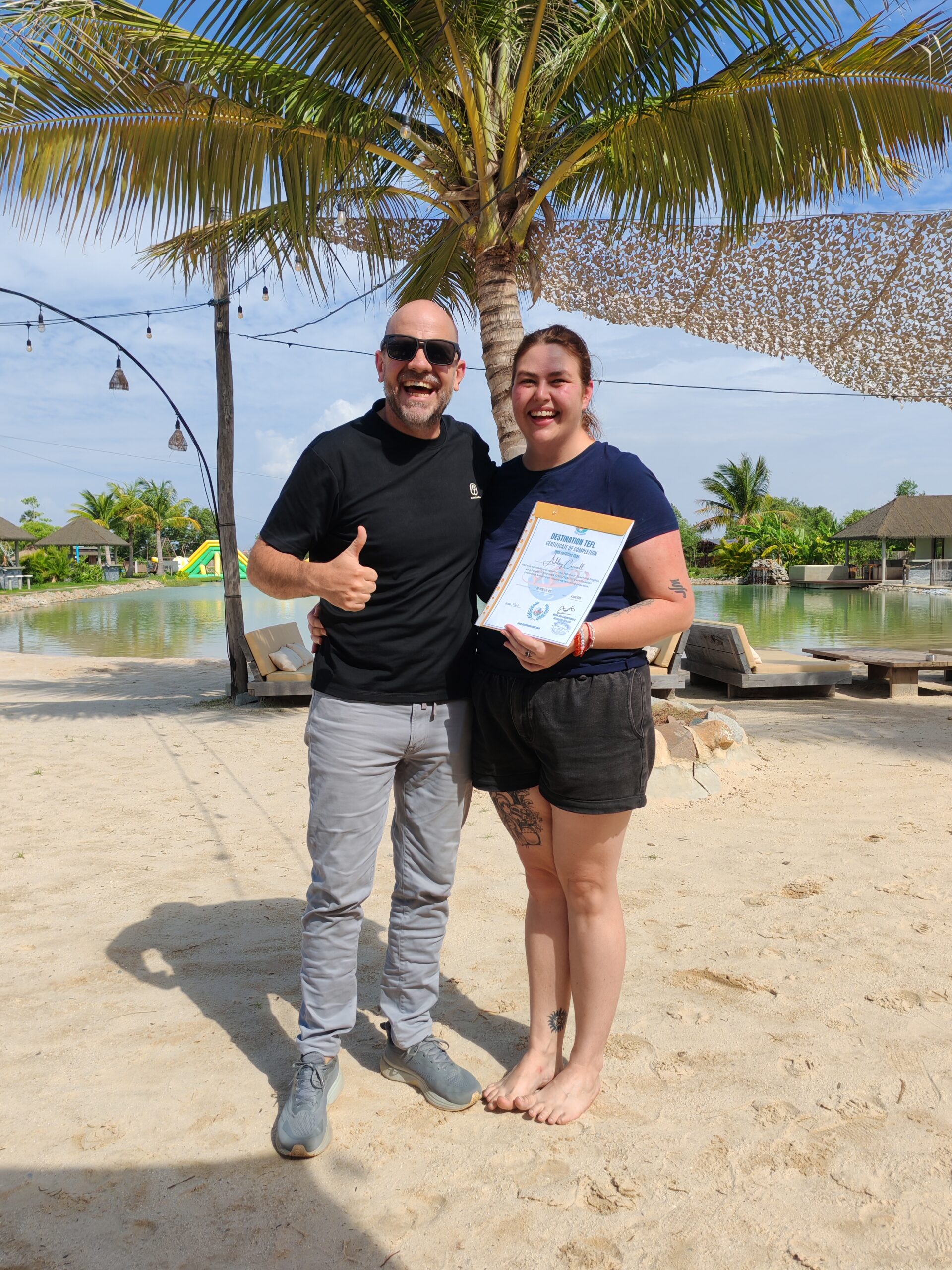 A Destination TEFL graduate receiving their certificate at the end of training